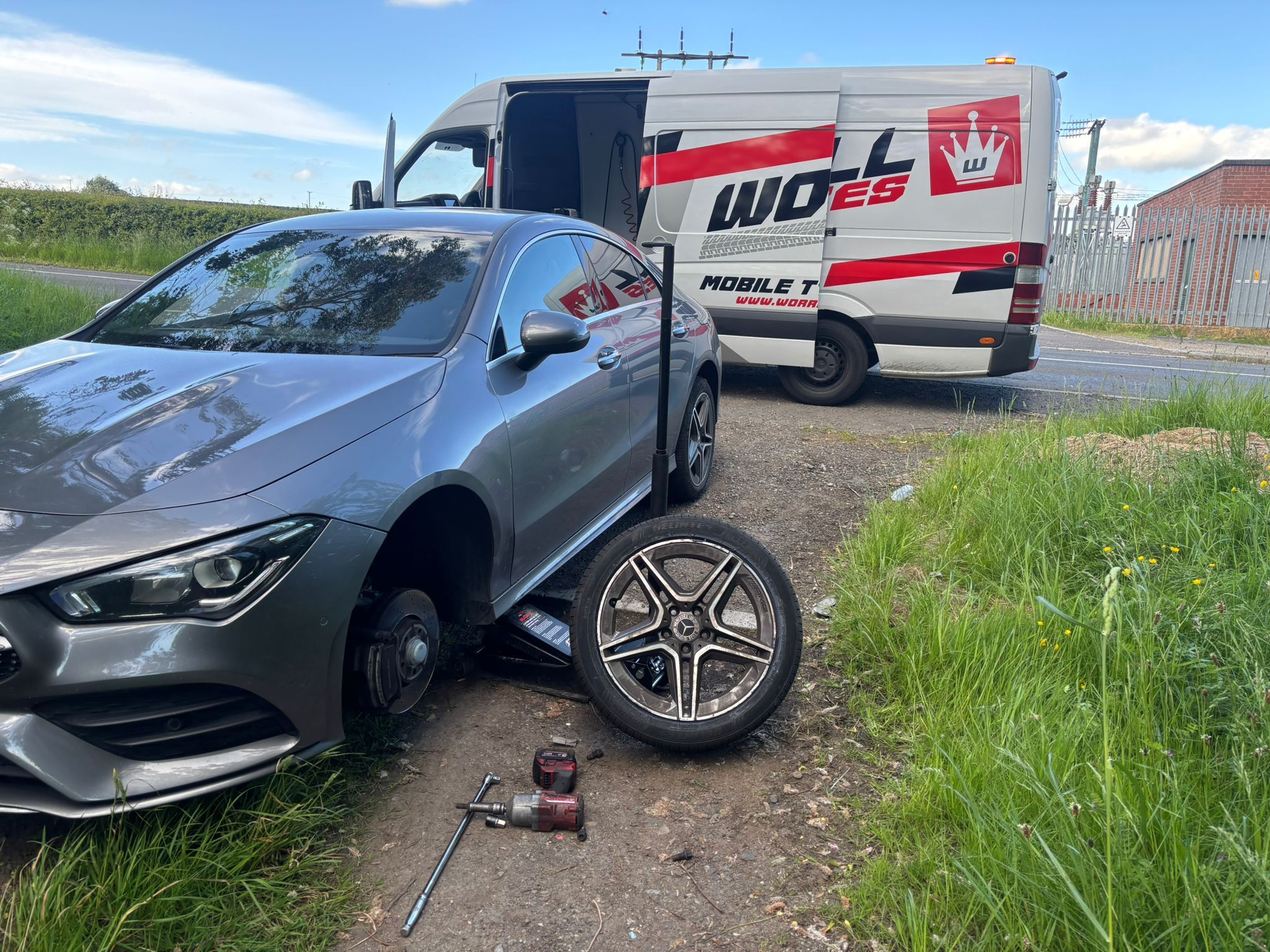 Worrall mobile fitting van replacing a tyre at the roadside on a country road