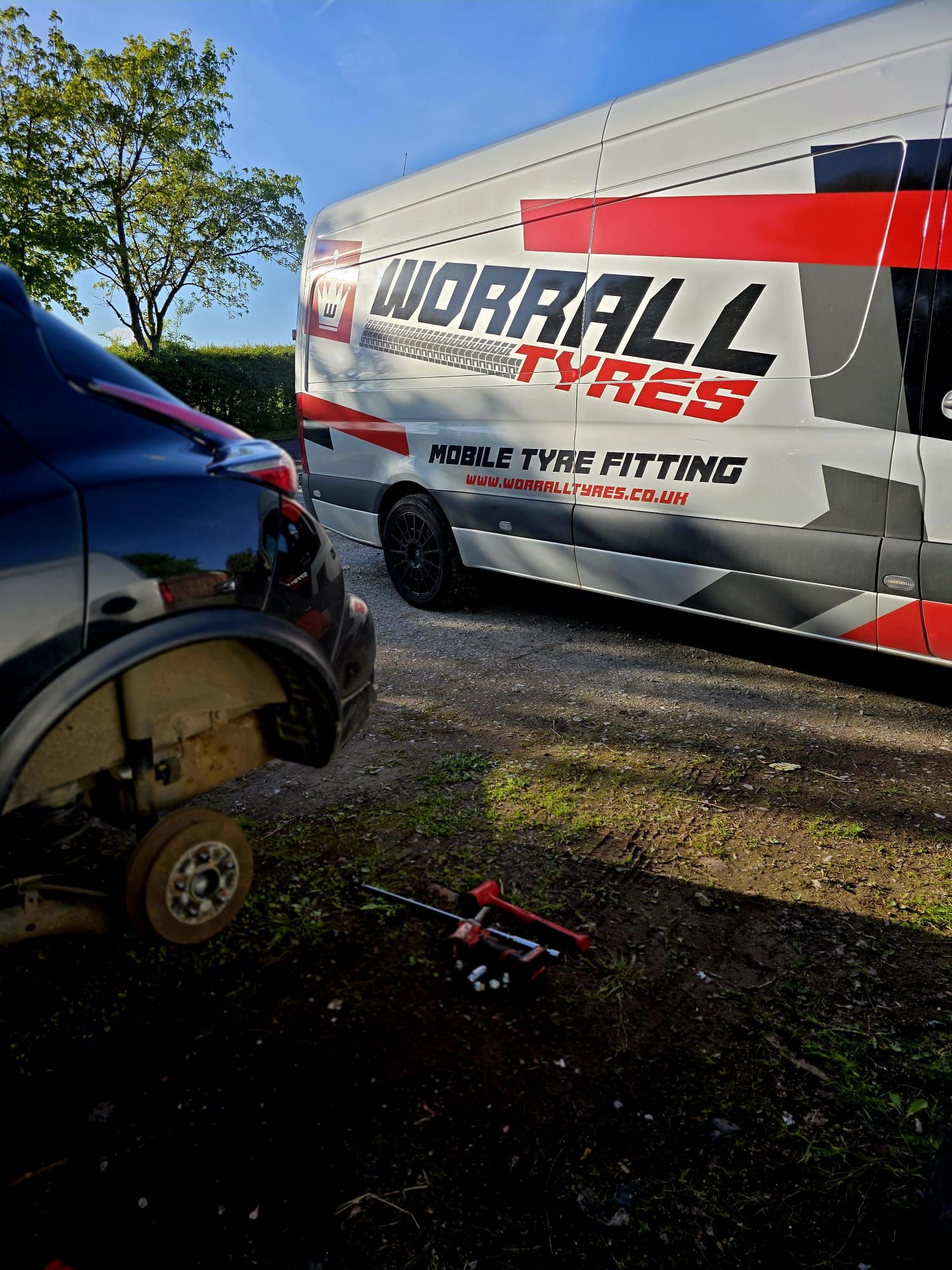 Worrall Tyres fitter replacing a tyre on a customer’s driveway